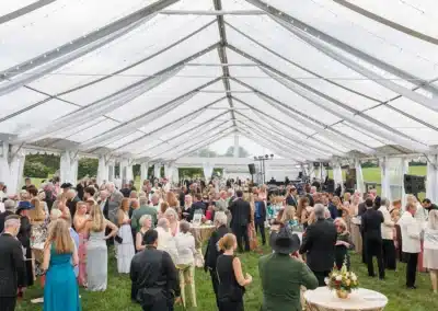 Social event under tent at Great Meadow